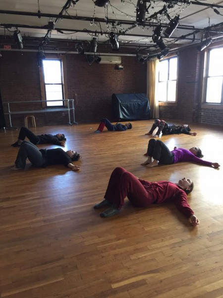 6 people laying on ground with knees up