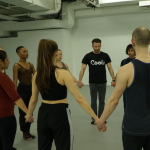 people standing holding hands