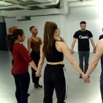 Participants holding hands standing in a circle.