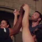 hands lifted up in the air while breathing together in a circle 