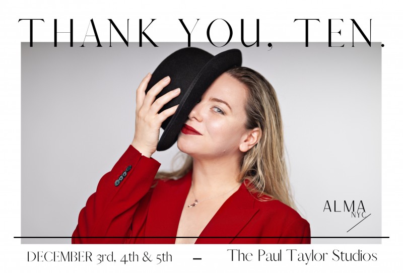 Close up image of Artistic Director Zanza Steinberg in a red blazer with a black bowler hat over one eye