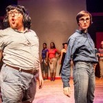 two dancers dressed in all denim face the audience with fierce and playful looks on their faces. 