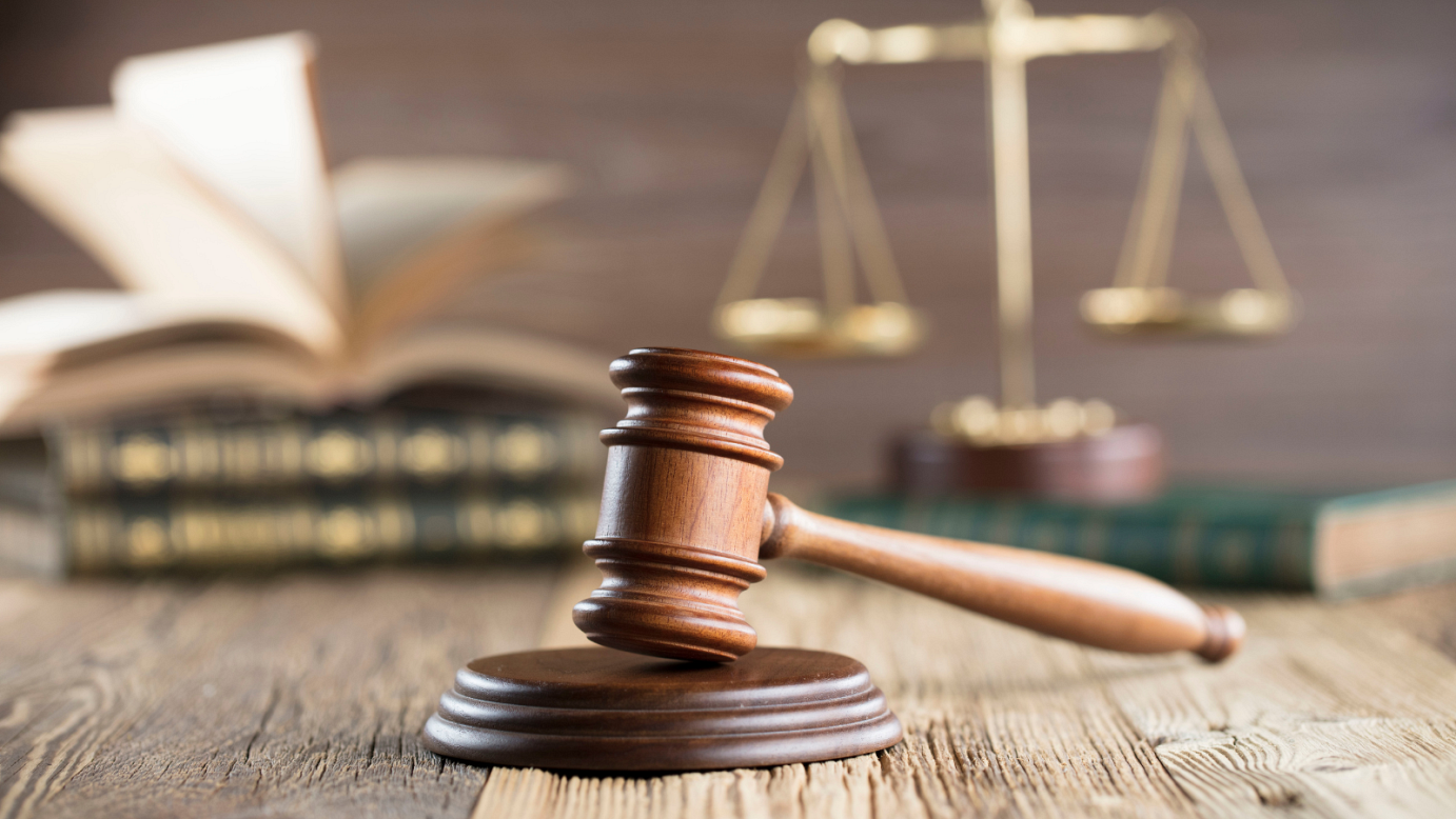 Image of a gavel, balance, and books