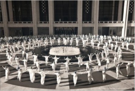 Dancers in white surround Lincoln Center's Revson Fountain