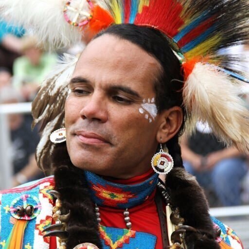 Headshot of Cliff wearing ceremonial headdress. 